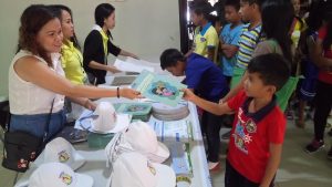 DSWD Field Office VIII employees distribute storybooks and other IEC materials on SHIELD Against Child Labor Project during a Children's Conference held on Wednesday in the Municipality of Kananga in Leyte.